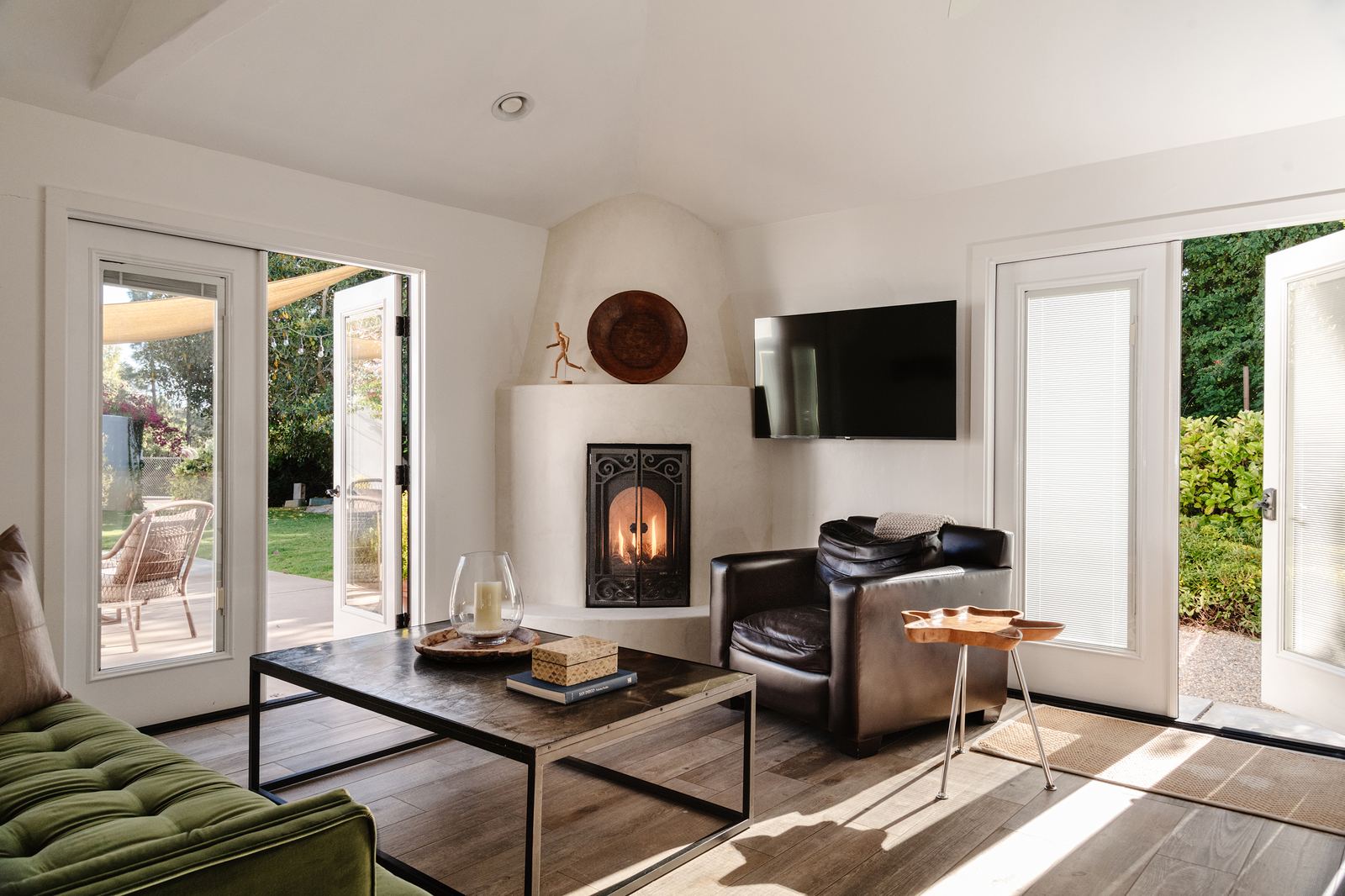 Living room with fireplace, doors open to yard