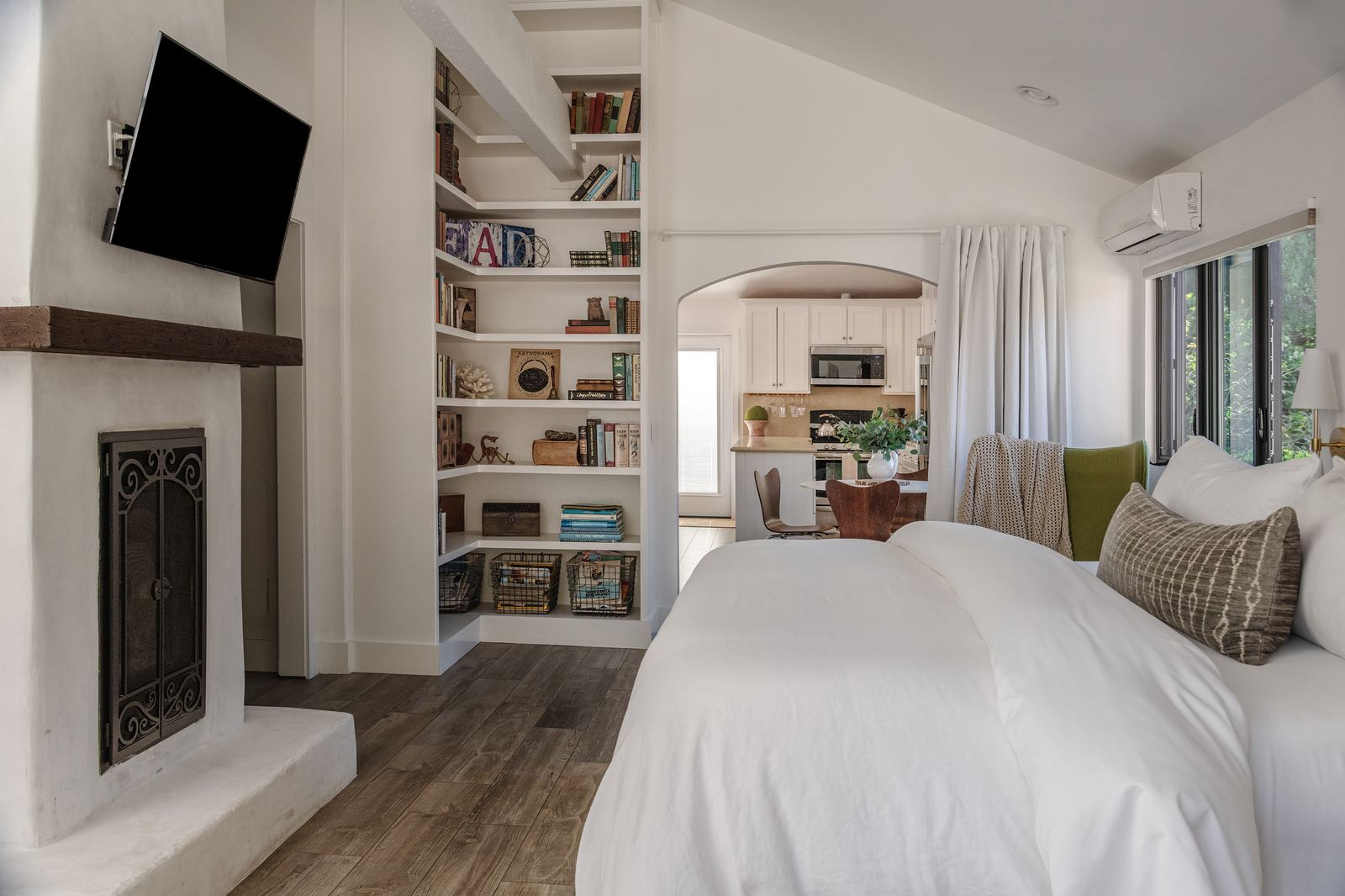 Bedroom with fireplace and view to kitchen
